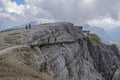 Hikers on the Lagazuoi mountain on the Dolomites with the refuge coming from the Falzarego pass by the cable car, near Cortina d`A