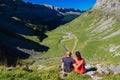 Hikers looking at the glacial valley of Ordesa National Park on a sunny day