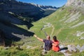 Hikers looking at the glacial valley of Ordesa National Park on a sunny day