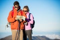 Hikers looking at trail map Royalty Free Stock Photo