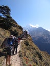 Hikers making their way up busy trail from Namche Bazaar with Thamserku in the background, Sagarmatha National Park, Nepal Royalty Free Stock Photo