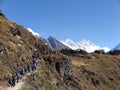 Hikers making their way up busy trail from Namche Bazaar with views of snow-capped Mt Taboche partial, Everest & Lhotse, Nepal