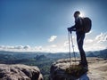 Hikers in mountains. Male strong carrier with backpack