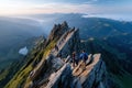 Hikers on a narrow mountain ridge at sunrise Royalty Free Stock Photo