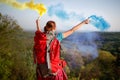 Hikers in nature with raised torch with smoke