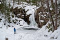 Hikers near frozen Kinsman Falls in Franconia Notch State Park during winter . New Hampshire mountains. USA Royalty Free Stock Photo