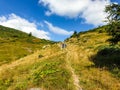 Hikers on Paltinu Saddle, Iorgovanu Mountains, Romania