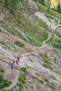 Hikers on a path on mountain slope