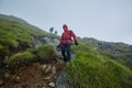 Hikers in raincoats on mountain Royalty Free Stock Photo