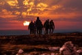 Hikers reach mountain top at sunset