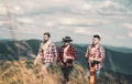 Hikers relaxing on top of a mountain and enjoying the view of valley. Young people on mountain hike. Gipsy. Travel and