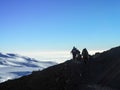 Hikers on the ridge ascend mount kilimanjaro the tallest peak in africa Royalty Free Stock Photo