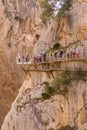 Hikers by runway in a stone wall