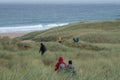 Hikers at Sandwood Bay, Highlands of Scotland. Remote bay with white sand, dunes and reeds.