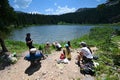 Hikers on shore of Hassell Lake in Arapaho National Forest, Colorado