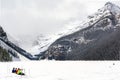 Hikers Sitting on Frozen Alpine Lake