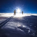 Hikers and snowfall in winter mountains