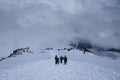 Hikers on a snowy mountain trail