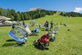 Hikers stand behind the path on the lawn near an alpine refuge