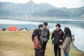 Hikers standing with chatting enjoy lake view