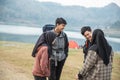 Hikers standing with chatting enjoy lake view