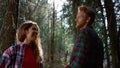 Hikers standing in forest. Handsome man hugging woman in woods