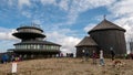 Hikers on summit. A meteorological observatory at Schneekoppe mountain - Sniezka. Giant Mountains, Na