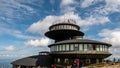 Hikers on summit. A meteorological observatory at Schneekoppe mountain - Sniezka. Giant Mountains, Na