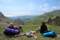 Hikers takes a rest on pass in mountains Royalty Free Stock Photo