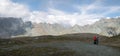 Hikers taking a break in alpine environment surrounded by rocky peaks, Austrian Alps, Europe