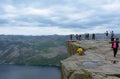 Hikers taking pictures while posing on the edge of the cliff