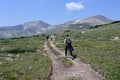 Hikers on trail in alpine tundra above St Mary's Glacier and treeline, Colorado.