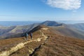 Hikers on a trail high in the mountains in autumn