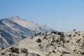 HIkers traversing the granite peaks in Yosemite