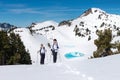 Hikers Trek Through a Snowy Mountain Landscape Royalty Free Stock Photo