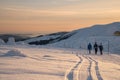 Hikers, trekkers walking in heavy snowfall during winter trip in mountains. There is a lot of snow, frost and fog