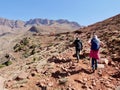 Hikers trekking in Ourika Valley to traditional Berber village Tizi N& x27;Oucheg, High Atlas Mountains, Morocco. Royalty Free Stock Photo