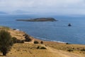 Hikers on the vast grassland of Maria Island