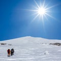 Hikers walk through a winter hills