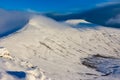 Hikers and walkers on a cold, snow covered mountain in the early morning sunshine Pen-y-Fan Royalty Free Stock Photo