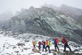 Hikers walking at the bottom of Grossglockner mountain. Royalty Free Stock Photo