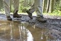 Hikers Walking Through Mud Puddle Royalty Free Stock Photo