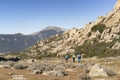 Hikers walking in a path in La Pedriza, National Park of mountain range of Guadarrama in Manzanares El Real, Madrid, Spain