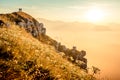 Hikers walking at sunrise on top of italian alps mountains Royalty Free Stock Photo