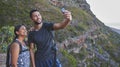 Hikes with you are always the best. a young couple taking photos while out on a hike in a mountain range outside. Royalty Free Stock Photo
