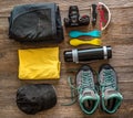 Hiking accessories on wooden background