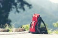 Hiking backpack travel gear on mountain. Items include hiking boots,