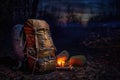 hiking backpack beside a warm campfire at night