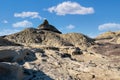 Striking black pyramid and pinnacle tower above the badlands