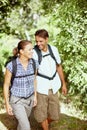 Hiking is the best excercise. A young couple walking in the park with their hiking gear. Royalty Free Stock Photo